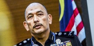 Police: Editor of Book with Cover “Insulting” Malaysian Coat of Arms Traced in Australia