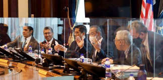 Cabinet Members Meet Behind Transparent Shields